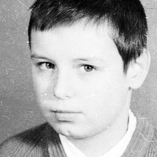 Young boy in vintage portrait-style photograph.