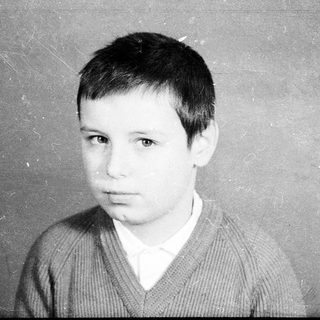 Young boy in vintage portrait-style photograph.