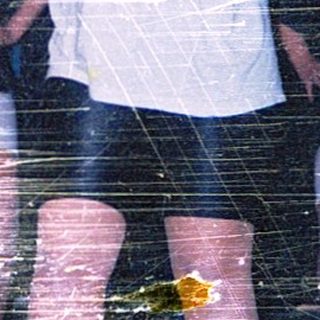 People standing in wet, reflective environment.