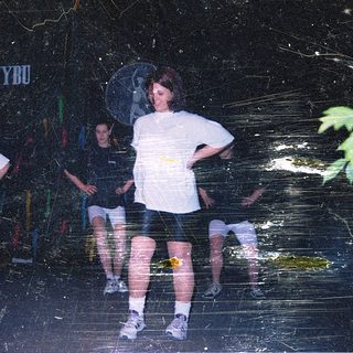 People standing in wet, reflective environment.