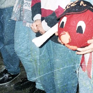 Group of teens holding toy in indoor setting.