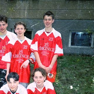 Young soccer team in red and white uniforms.