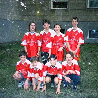 Young soccer team in red and white uniforms.