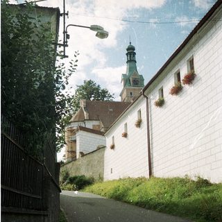 Quaint street leading to historic church tower.