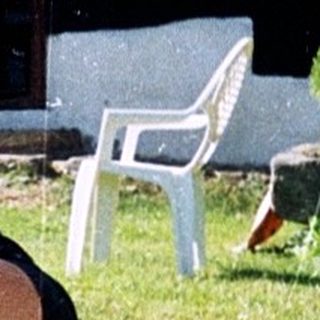 Man relaxing outdoors with wine glass.