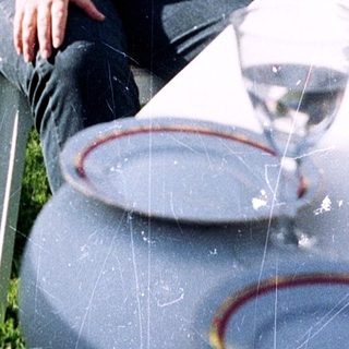 Man relaxing outdoors with wine glass.