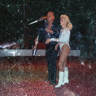 Couple performing on stage with disco lights.
