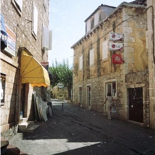 Quaint European village street with stone buildings.
