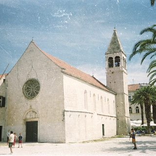 Medieval stone church with bell tower.