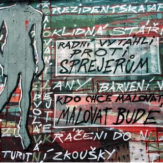 Graffiti protest mural with Czech/Slovak slogans.