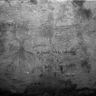 Graffiti with Polish text and a spiral design.