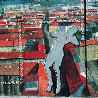 Urban scene with falling figure amid text about Prague's old town.