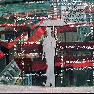 Urban mural with graffiti text and silhouette under umbrella.