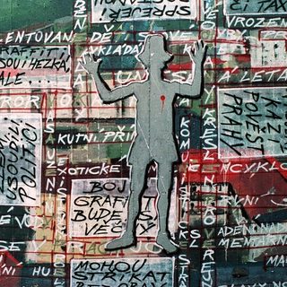 Vibrant mural with graffiti-style text and stenciled political/social commentary.