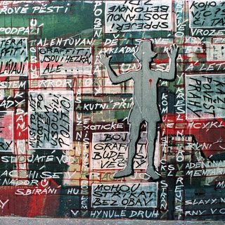 Vibrant mural with graffiti-style text and stenciled political/social commentary.