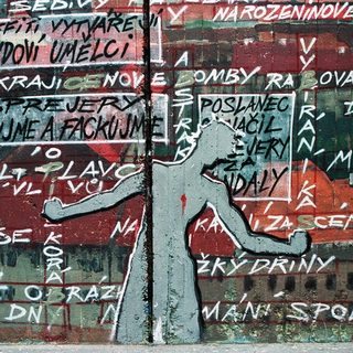 Street mural with Czech graffiti protest slogans.