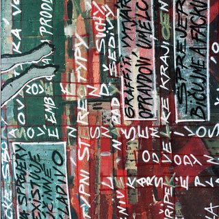Graffiti wall with Czech slogans and artistic text.