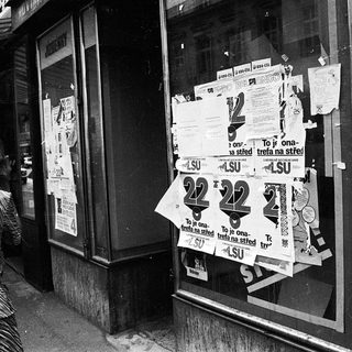 Closed shop windows covered with protest posters.