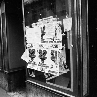 Closed shop windows covered with protest posters.