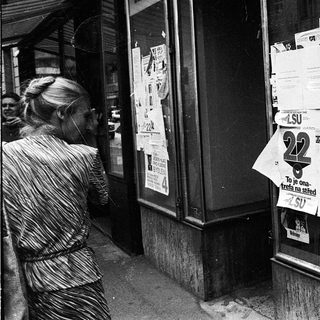 Closed shop windows covered with protest posters.