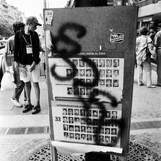 Missing persons posters vandalized with graffiti.