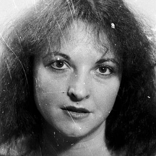 Wet-haired woman with curly hair, black-and-white portrait.