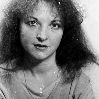 Wet-haired woman with curly hair, black-and-white portrait.