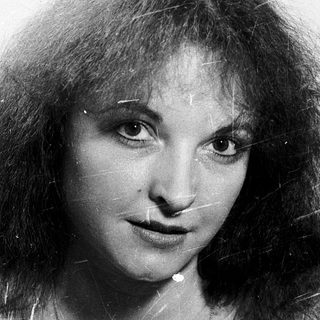 Portrait of a woman with long, wavy hair.