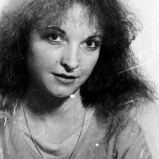 Portrait of a woman with long, wavy hair.