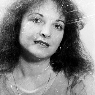 Wet-haired woman with expressive face, black-and-white.