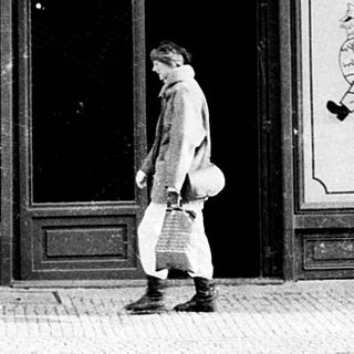 Classic beer hall entrance with man walking past.