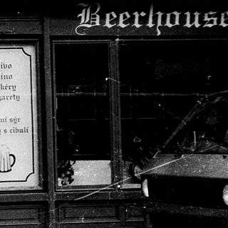 Classic beer hall entrance with man walking past.