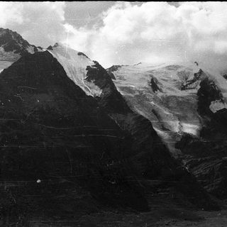 Mountainous landscape with snow-covered peaks and volcanic terrain.