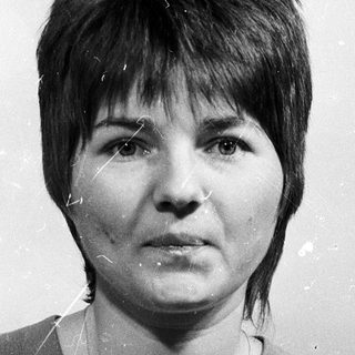 Black-and-white portrait of a woman with short hair.
