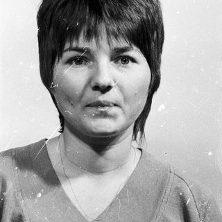 Black-and-white portrait of a woman with short hair.