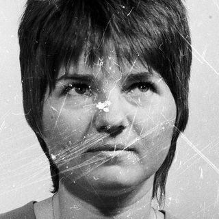 Black-and-white portrait of a person with short hair.