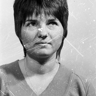 Black-and-white portrait of a person with short hair.