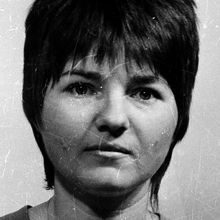 Black-and-white portrait of a woman with short hair.