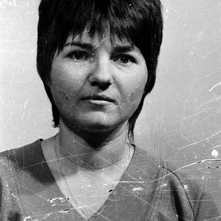 Black-and-white portrait of a woman with short hair.