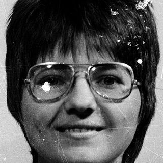 Vintage portrait of woman wearing glasses.