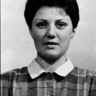 Portrait of a woman in a plaid shirt.