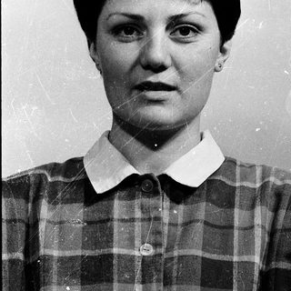 Portrait of a woman in a plaid shirt.
