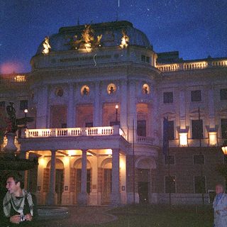 Neoclassical building illuminated at night.