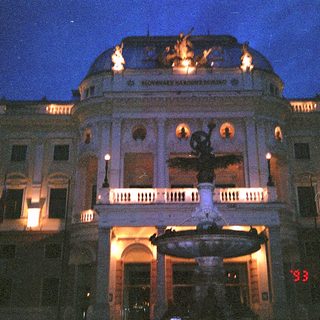 Neoclassical building illuminated at night.