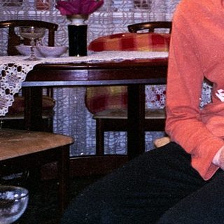 Three women smiling indoors together.