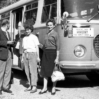 People boarding vintage bus labeled "Horecky" in 1950s.