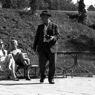 People relaxing outdoors near a building.