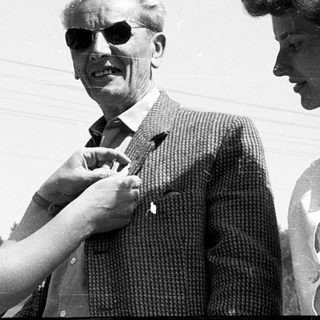 Four people posing outdoors in mid-20th-century attire.
