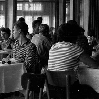 Group of women dining together indoors.