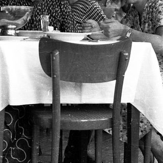 People dining together in a café, mid-20th century.
